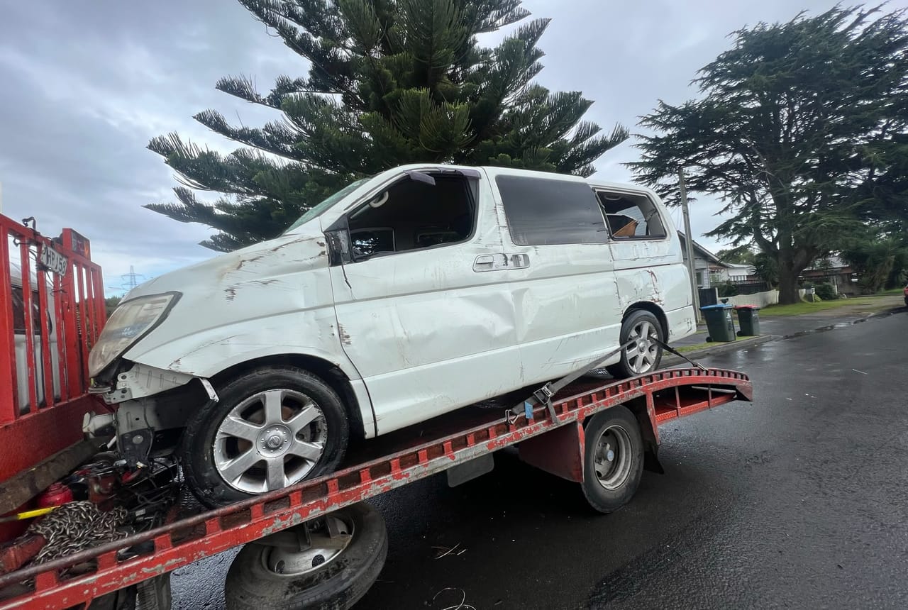Nissan Elgrand van loaded on a flatbed for removal in Palmerston North